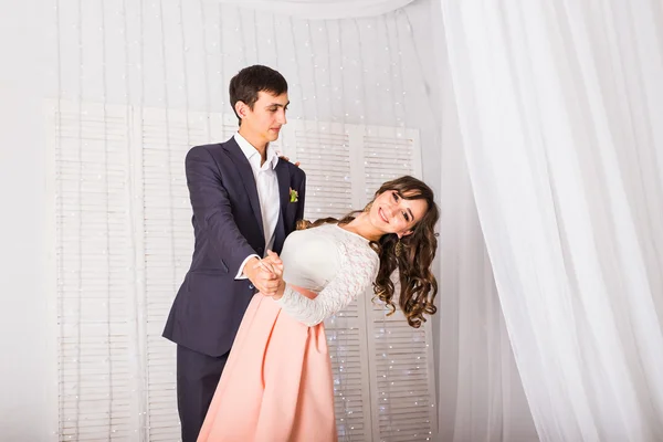 Loving young couple dancing together at home to celebrate a special occasion — Stock Photo, Image