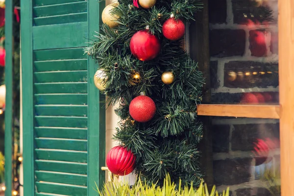 Christmas Red ball decorated windows on vintage house — Stock Photo, Image