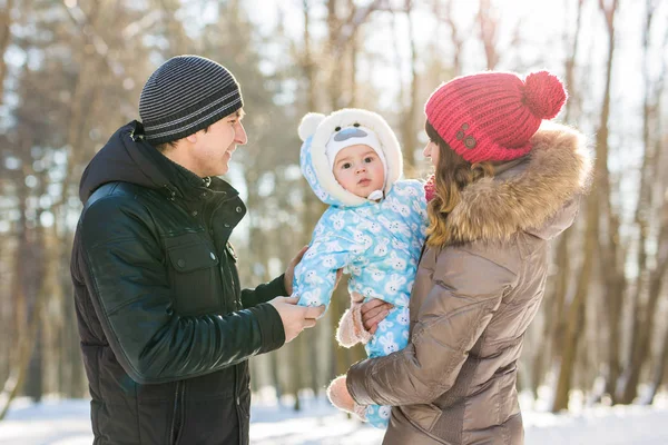 Parenthood, season and people concept - happy family with child in winter clothes outdoors — Stock Photo, Image
