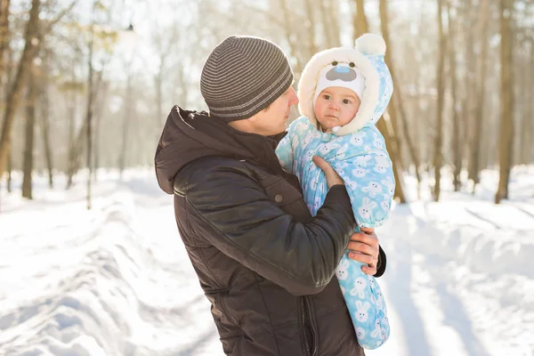 Happy family on a winter walk in nature. Dad with baby boy — Stock Photo, Image