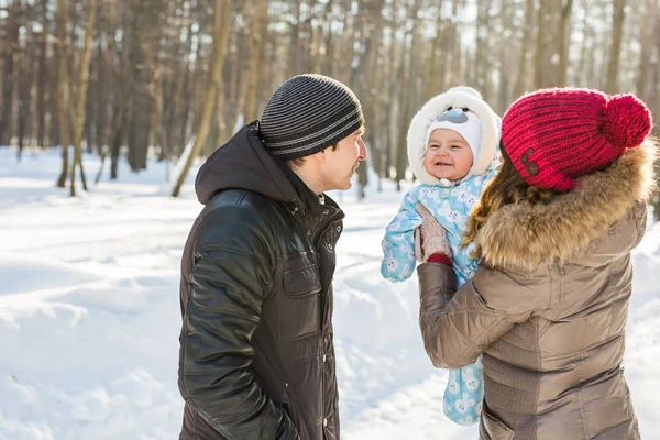 Winter portrait of happy young family of 3 people — Stock Photo, Image