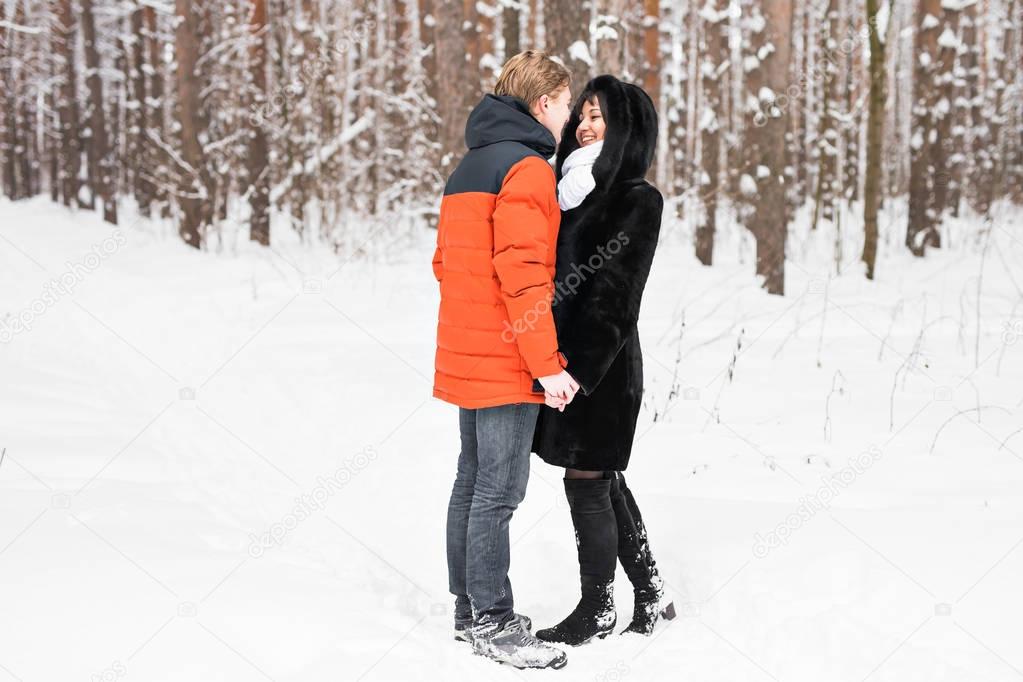 Young couple kissing on winter day