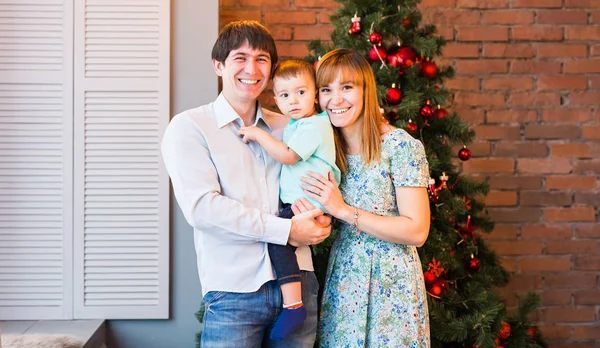 Retrato da família do Natal na sala de estar home do feriado, casa que decora pela árvore de Natal — Fotografia de Stock