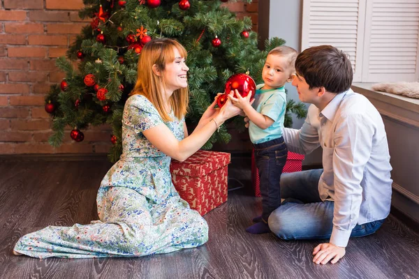 Navidad, x-mas, familia, gente, concepto de felicidad - padres felices jugando con el niño lindo — Foto de Stock