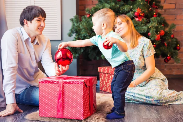 家族、クリスマス、クリスマス、冬、幸福、人のコンセプト - クリスマス ツリーの下に座って赤ちゃん男の子と家族の笑顔 — ストック写真
