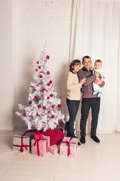 Lachende en gelukkige familie in de buurt van de kerstboom — Stockfoto