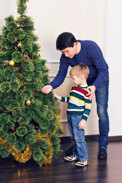 Vader en zoon zijn de kerstboom versieren — Stockfoto