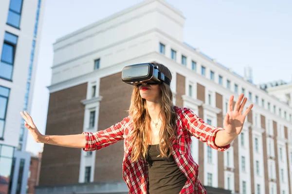 Woman with virtual reality goggles in the city