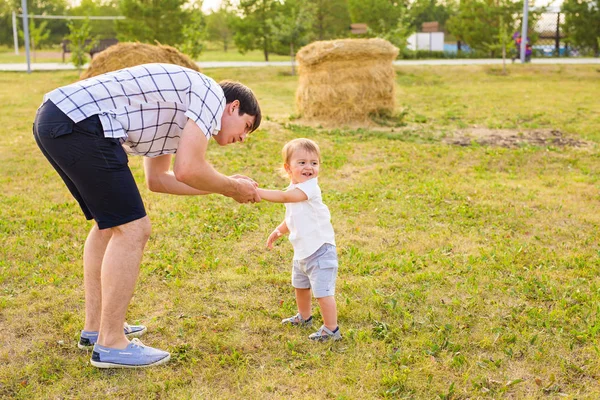Feliz familia padre e hijo en el prado en el verano en la naturaleza — Foto de Stock