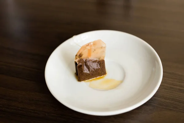 Used Tea Bag on White plate — Stock Photo, Image