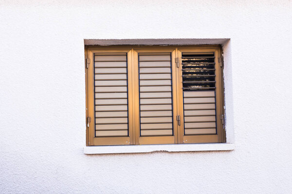 Window with white shutters. Windows are closed