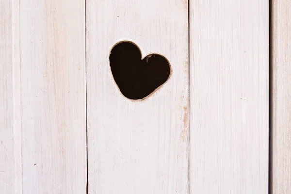Wooden board with cut out heart shape — Stock Photo, Image