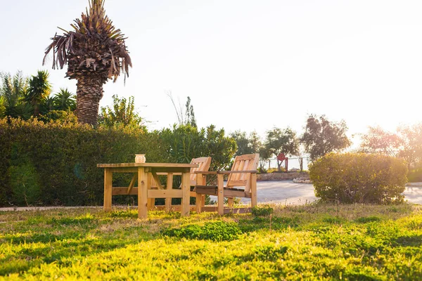 Wooden outdoor furniture. Lounge chairs in hotel garden invite you to relax