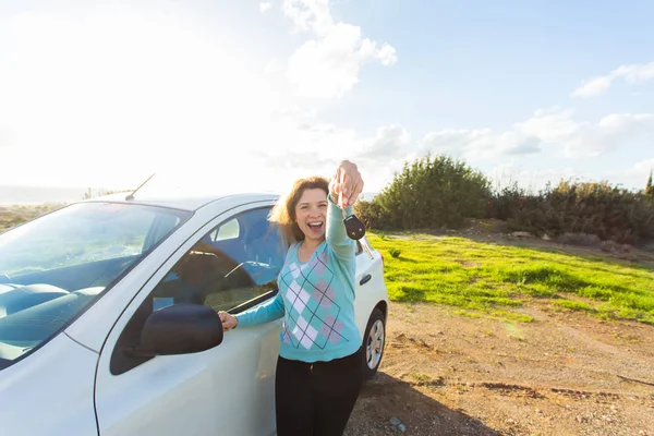 Auto-Geschäft, Autoverkauf, Konsum und Menschen-Konzept - glückliche Frau mit neuem Autoschlüssel im Freien — Stockfoto
