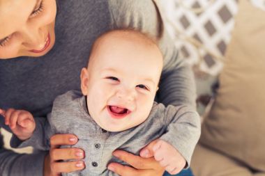 Annesi ile mavi gözlü mutlu gülümseyen çocuk portresi