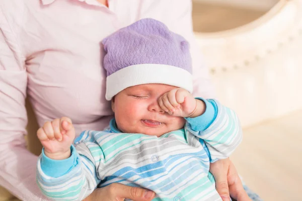 Portrait of newborn tired baby boy rubbing eyes — Stock Photo, Image