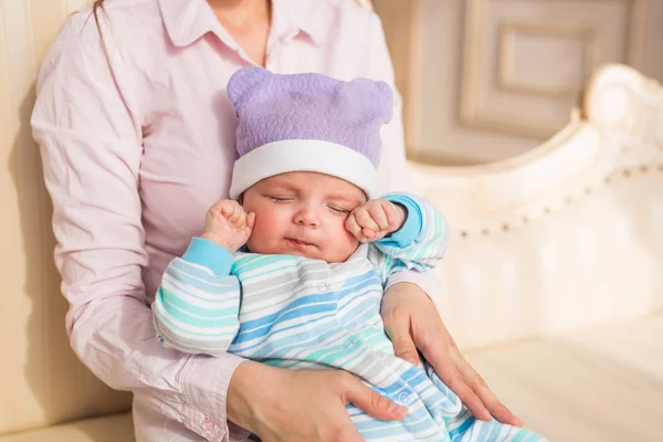 Tired newborn baby boy rubbing eyes — Stock Photo, Image