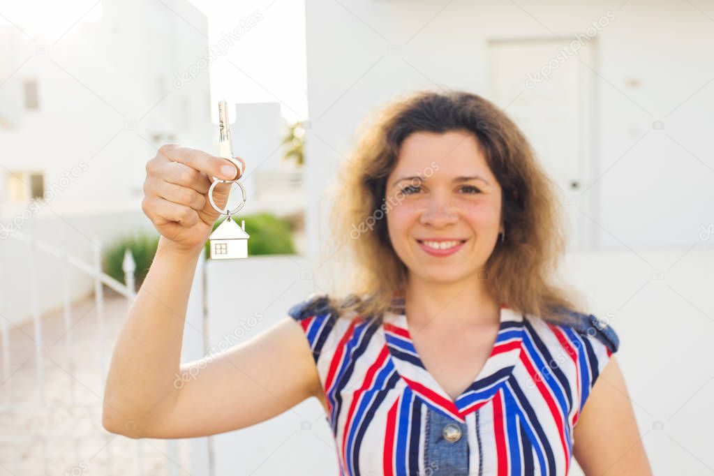 Happy house owner or renter showing keys and looking at you