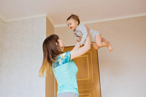 Happy mother with adorable baby boy in the bedroom. — Stock Photo, Image