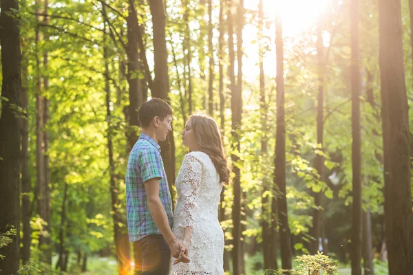 Portrait of a young romantic couple embracing each other on nature — Stock Photo, Image