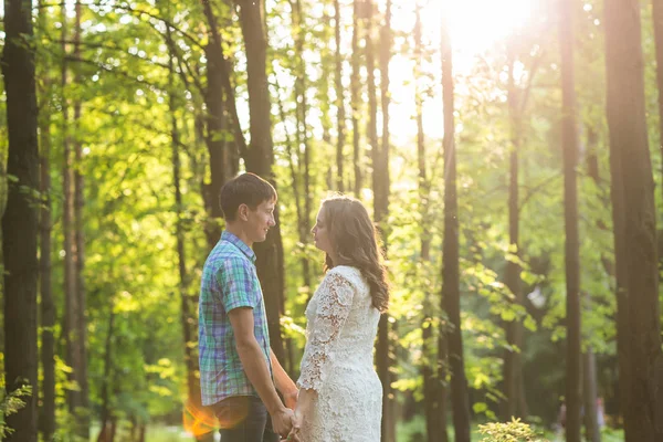 Portrait of a young romantic couple embracing each other on nature — Stock Photo, Image