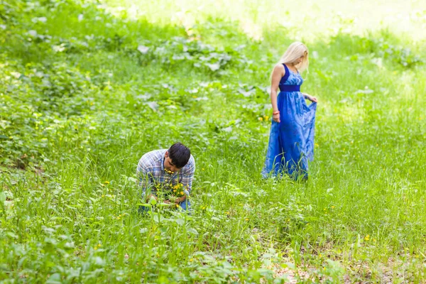 Молодой человек собирает цветы для своей женщины — стоковое фото