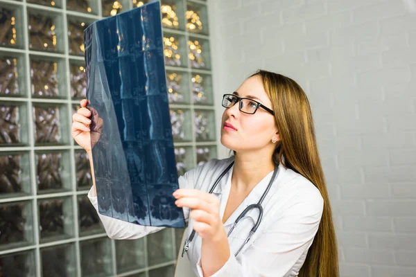 Woman Doctor Looking at X-Ray Radiography in doctors office