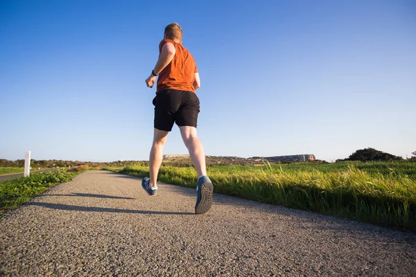 Hombre corriendo al aire libre corriendo para el éxito. Corredor de fitness masculino atleta deportivo en sprint a gran velocidad en hermoso paisaje — Foto de Stock