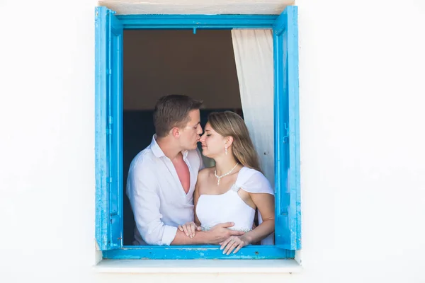 Loving couple in the window — Stock Photo, Image