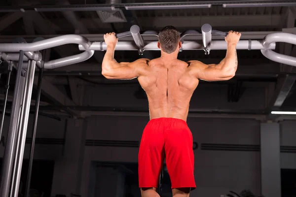 Silný muž dělá pull ups — Stock fotografie