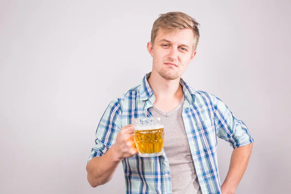 Hombre guapo sosteniendo una taza de cerveza . — Foto de Stock