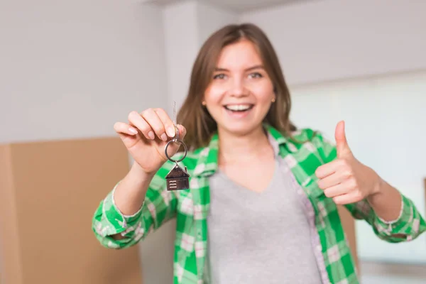 Happy apartment owner or renter showing keys and making thumbs up gesture — Stock Photo, Image