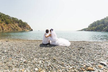 Düğün çift birlikte sahilde oturan genç tr