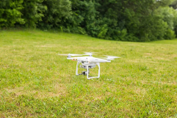 Ufa, Russia. - 6 June 2016 : White drone, quadrocopter with photo camera flying — Stock Photo, Image