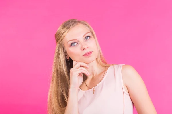 Photo of thoughtful serious female model, tries to remember important information, cant find quick answer in mind, poses over pink studio with copy blank space for your text — Stockfoto