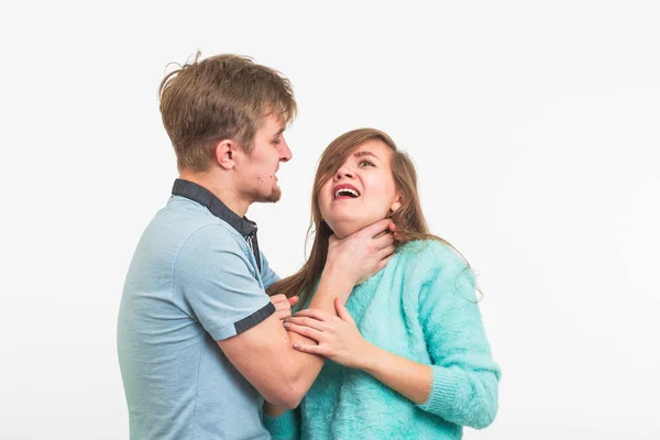 Woman victim of domestic violence and abuse. The quarrel in the family. A man beats a young woman on white background — Stock Photo, Image