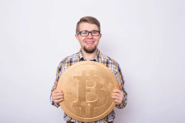 Hombre de negocios feliz sosteniendo gran bitcoin de oro sobre fondo blanco. Cripto moneda, dinero virtual, internet y concepto de economía — Foto de Stock