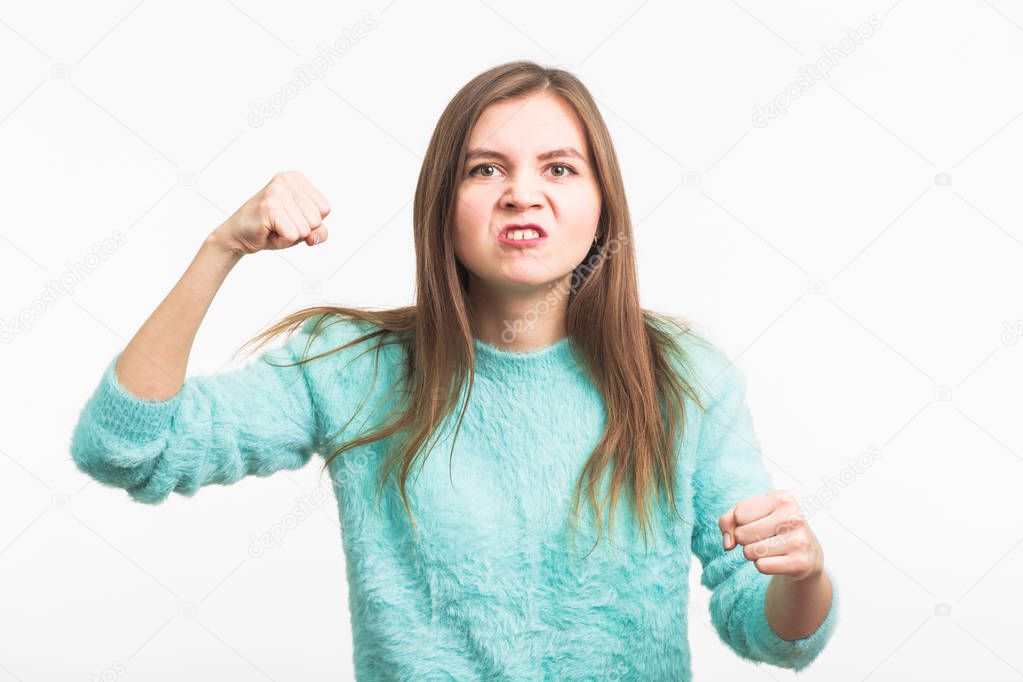 Angry aggressive woman with ferocious expression on white background