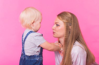 genç anne ve kızı birlikte eğleniyor arka plan pembe