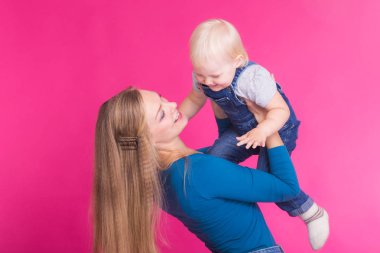 Anne ve kızı, pembe arka plan izole eğleniyor