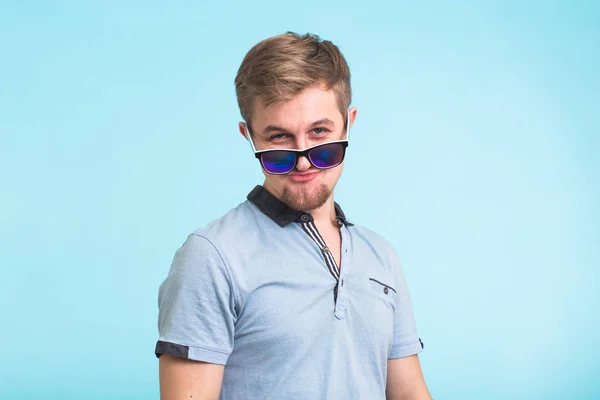 Retrato de um homem bonito vestido com camiseta de pólo em fundo azul — Fotografia de Stock