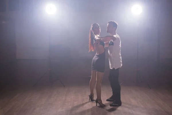 Giovane coppia che balla social danse kizomba o bachata o semba o taraxia in fondo alla classe di danza — Foto Stock