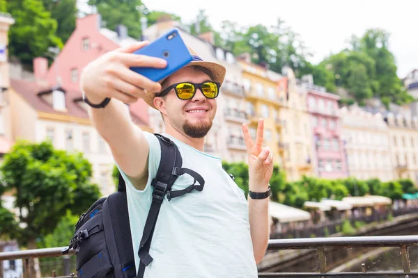 Avrupa şehri mobil akıllı telefon kamera ile selfie alarak yakışıklı adam. Tatil, seyahat ve tatil kavramı. — Stok fotoğraf