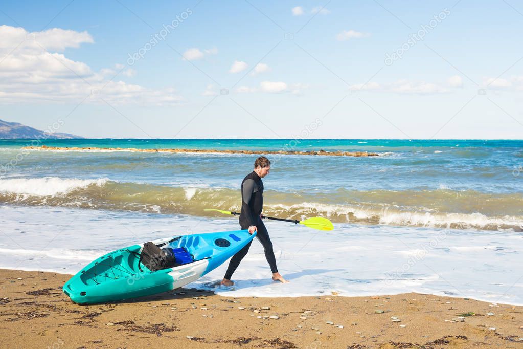 Kayaker holding his kayak