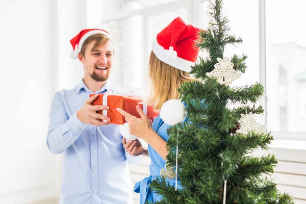 Ünnepi koncepció - Az ember karácsonyi ajándékot ad a barátnőjének — Stock Fotó