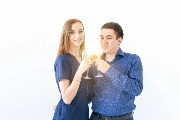 Homem e mulher comemorando a festa de Natal ou Ano Novo com copos de champanhe no fundo branco — Fotografia de Stock