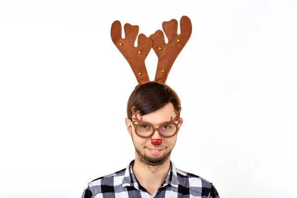 Christmas, holidays and funny concept - man with deer horns and rudolf nous on white background — Stock Photo, Image