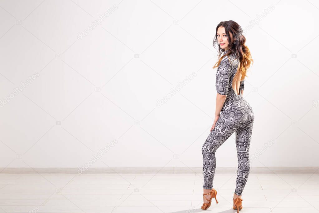 Latina dance, strip dance, contemporary and bachata lady concept - Woman dancing improvisation and moving her long hair on a white background with copyspace