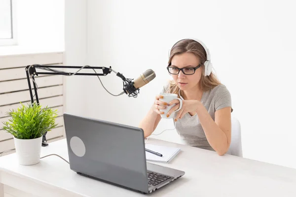 Radio host, streamer and blogger concept - Woman working as radio host at radio station sitting in front of microphone — Stock Photo, Image