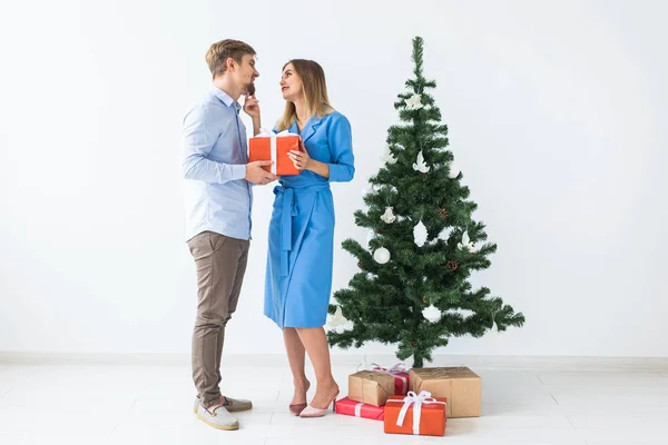 Holidays and celebration concept - Man giving a Christmas present to his girlfriend